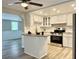 Modern kitchen with white cabinets, granite countertops, and stainless steel appliances at 3245 Bigelow Dr Dr, Holiday, FL 34691