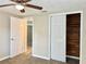 Bedroom with wood-look floors, ceiling fan and closet at 3245 Bigelow Dr Dr, Holiday, FL 34691