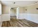 Open living room with wood-look flooring and access to other rooms at 3245 Bigelow Dr Dr, Holiday, FL 34691