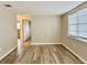 Bright living room featuring light brown vinyl plank flooring and neutral walls at 3245 Bigelow Dr Dr, Holiday, FL 34691