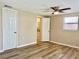 Spacious bedroom with wood-look flooring and large window at 3245 Bigelow Dr Dr, Holiday, FL 34691