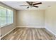 Charming bedroom with ceiling fan and large window at 3245 Bigelow Dr Dr, Holiday, FL 34691