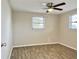 Spacious bedroom with wood-look floors and ceiling fan at 3245 Bigelow Dr Dr, Holiday, FL 34691