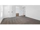 Bright bedroom with grey carpeting and multiple closets at 14499 Mount Ivy Rd, Brooksville, FL 34614