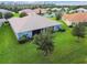 House back view, screened patio, and grassy backyard at 15626 Aurora Lake Cir, Wimauma, FL 33598
