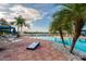 Relaxing resort-style pool with lounge chairs and cabanas at 15626 Aurora Lake Cir, Wimauma, FL 33598