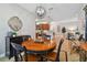 Bright dining room with a round table and access to kitchen and living room at 15626 Aurora Lake Cir, Wimauma, FL 33598