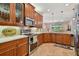 Spacious kitchen with stainless steel appliances and light wood cabinets at 15626 Aurora Lake Cir, Wimauma, FL 33598
