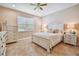 Spacious bedroom with a white bed frame and ample storage at 15626 Aurora Lake Cir, Wimauma, FL 33598