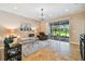 Bright living room with tiled floors, comfy seating, and access to a screened patio at 15626 Aurora Lake Cir, Wimauma, FL 33598