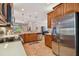 Eat-in kitchen with stainless steel appliances and ample cabinet storage at 15626 Aurora Lake Cir, Wimauma, FL 33598