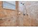 Walk-in shower with tiled walls and grab bar at 15626 Aurora Lake Cir, Wimauma, FL 33598