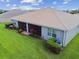 House back view, screened patio, and grassy backyard at 15626 Aurora Lake Cir, Wimauma, FL 33598