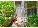 Brick walkway to the house entrance, surrounded by lush greenery at 15626 Aurora Lake Cir, Wimauma, FL 33598