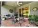 Relaxing screened patio with brick pavers and outdoor furniture, overlooking the backyard at 15626 Aurora Lake Cir, Wimauma, FL 33598