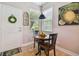 Charming breakfast nook with round table and black chairs near kitchen at 15626 Aurora Lake Cir, Wimauma, FL 33598