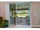 View of a screened patio with brick flooring and outdoor furniture from inside the house at 15626 Aurora Lake Cir, Wimauma, FL 33598