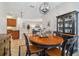 Well-lit dining area with a round table and view into the living room at 15626 Aurora Lake Cir, Wimauma, FL 33598