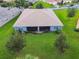 House back view, screened patio, and grassy backyard at 15626 Aurora Lake Cir, Wimauma, FL 33598
