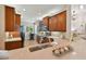 Well-equipped kitchen featuring wood cabinets, granite countertops, and a breakfast nook at 15626 Aurora Lake Cir, Wimauma, FL 33598