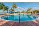 Community pool with palm trees and patio area at 15626 Aurora Lake Cir, Wimauma, FL 33598