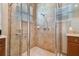 Walk-in shower with tiled walls and grab bar at 15626 Aurora Lake Cir, Wimauma, FL 33598