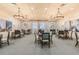 Spacious card room with tables, chairs, and artwork at 15626 Aurora Lake Cir, Wimauma, FL 33598