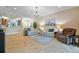 Spacious living area with tile floors, plush seating, and a view into the kitchen and dining area at 15626 Aurora Lake Cir, Wimauma, FL 33598