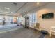 Fitness center with strength training equipment and lake views at 15626 Aurora Lake Cir, Wimauma, FL 33598