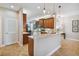 Modern kitchen with wood cabinets, granite countertops, and stainless steel appliances at 15626 Aurora Lake Cir, Wimauma, FL 33598