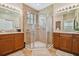 Large bathroom with double vanity and walk-in shower at 15626 Aurora Lake Cir, Wimauma, FL 33598