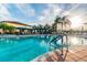 Large community swimming pool with plenty of space for relaxation at 15626 Aurora Lake Cir, Wimauma, FL 33598