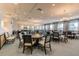 Elegant card room with multiple tables and large windows at 15626 Aurora Lake Cir, Wimauma, FL 33598