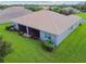 House back view, screened patio, and grassy backyard at 15626 Aurora Lake Cir, Wimauma, FL 33598