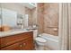 Clean bathroom with a shower/tub combo, wood vanity, and grab bars at 15626 Aurora Lake Cir, Wimauma, FL 33598