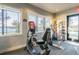 Fitness center featuring modern exercise bikes with lake views at 15626 Aurora Lake Cir, Wimauma, FL 33598