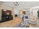 Open living room showcasing a flat-screen TV, comfortable seating, and views into the kitchen at 15626 Aurora Lake Cir, Wimauma, FL 33598