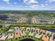 Aerial view of a large community with houses and lakes at 15626 Aurora Lake Cir, Wimauma, FL 33598