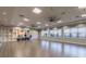 Bright yoga studio with hardwood floors, mirrors, and storage at 15626 Aurora Lake Cir, Wimauma, FL 33598