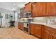 Kitchen with stainless steel appliances, wood cabinetry, and a breakfast bar at 15626 Aurora Lake Cir, Wimauma, FL 33598