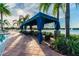 Relax in this shaded poolside cabana with comfortable seating at 15626 Aurora Lake Cir, Wimauma, FL 33598