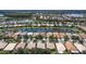 Aerial view of a community with many homes situated on the lake at 4949 Sandy Brook Cir, Wimauma, FL 33598