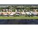Aerial view showcasing the house, backyard, and lakeside setting at 4949 Sandy Brook Cir, Wimauma, FL 33598