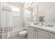 Clean bathroom with a shower-tub combo, white tile, and a vanity with ample counter space at 4949 Sandy Brook Cir, Wimauma, FL 33598