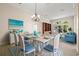 Charming dining room features a modern chandelier, dining table with seating and stylish decor at 4949 Sandy Brook Cir, Wimauma, FL 33598