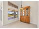 Dining area showcases a wood hutch and a window with a view of the screened lanai at 4949 Sandy Brook Cir, Wimauma, FL 33598