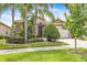 Beautifully landscaped single-story home featuring a well-manicured lawn and a side-entry garage at 4949 Sandy Brook Cir, Wimauma, FL 33598
