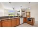 Kitchen with wood cabinetry and granite countertops, an island, plus modern appliances at 4949 Sandy Brook Cir, Wimauma, FL 33598