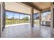 Screened lanai with tile flooring offering tranquil water views at 4949 Sandy Brook Cir, Wimauma, FL 33598