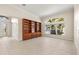 Bright living room with built-in shelving and a large window with tropical views at 4949 Sandy Brook Cir, Wimauma, FL 33598